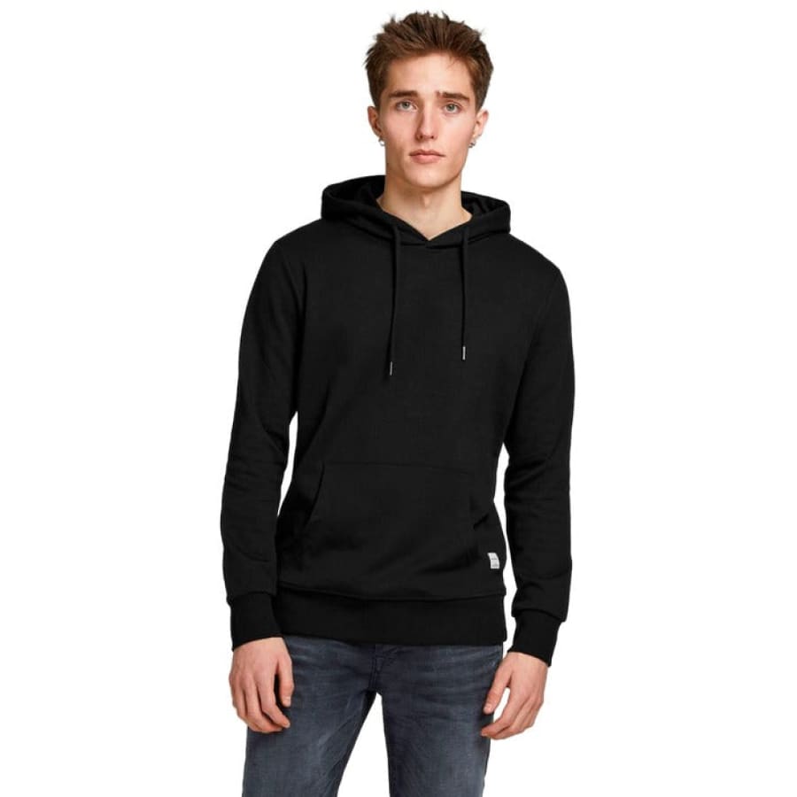 Man in Calvin Klein black hoodie, trendy Tommy Hilfiger pullovers.