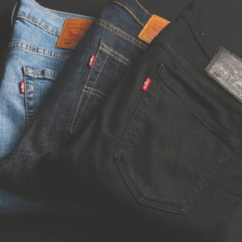 Three pairs of Levi’s jeans in varied washes displayed for fashion inspiration.