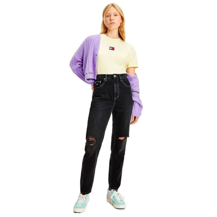 Model in purple cardigan and women’s black jeans