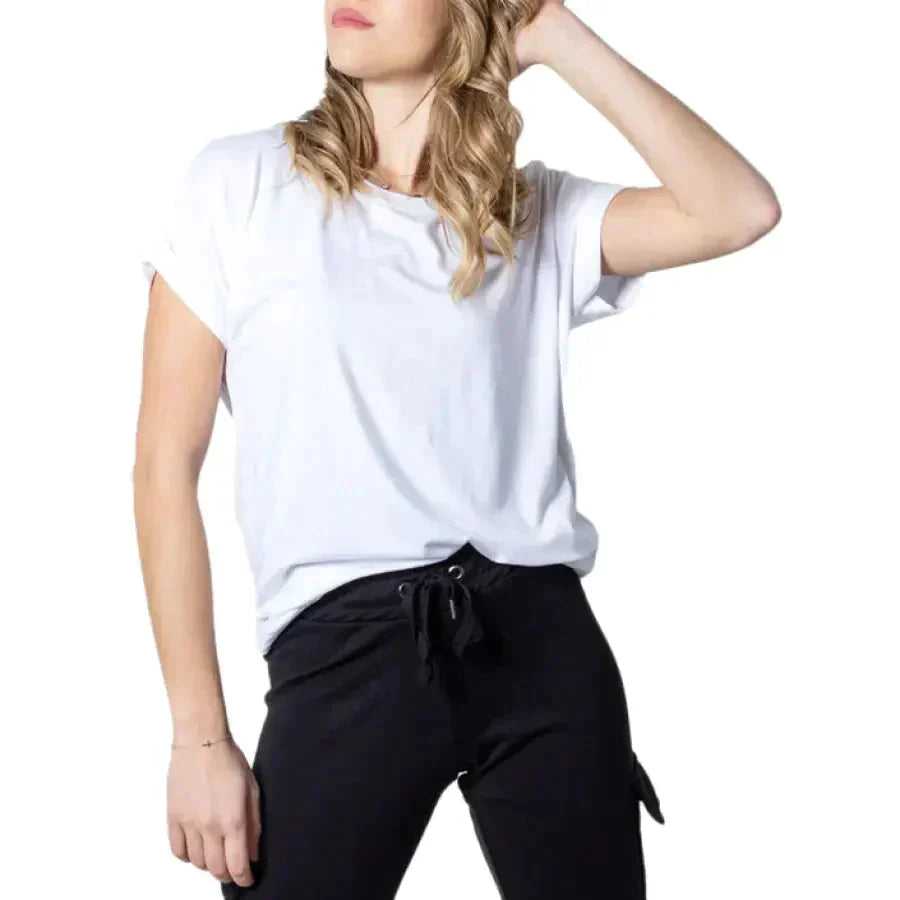 Woman in women’s tops collection, white top and black pants