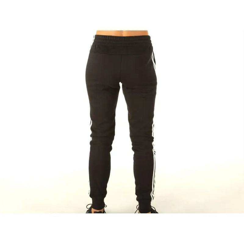 Adidas black sweatpants featuring white side stripes made of comfortable fabric ideal for jogging and casual wear
