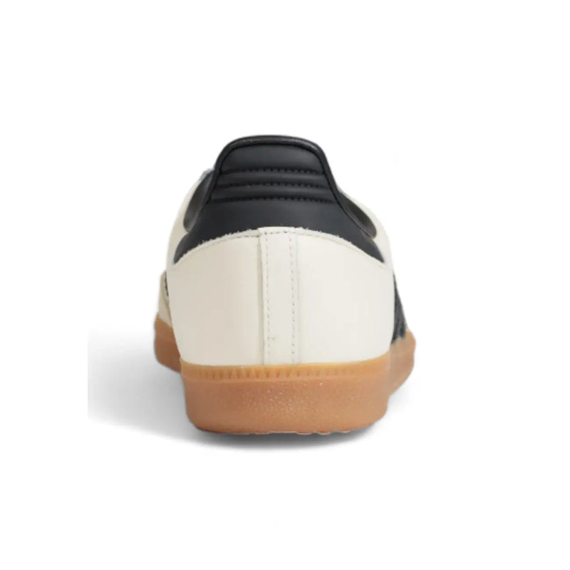 Adidas women leather sneakers featuring a black and cream samba design with white laces and gum rubber sole