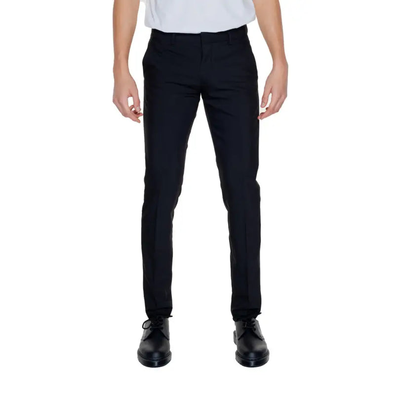Men’s slim-fit black dress pants with pressed creases and black lace-up shoes