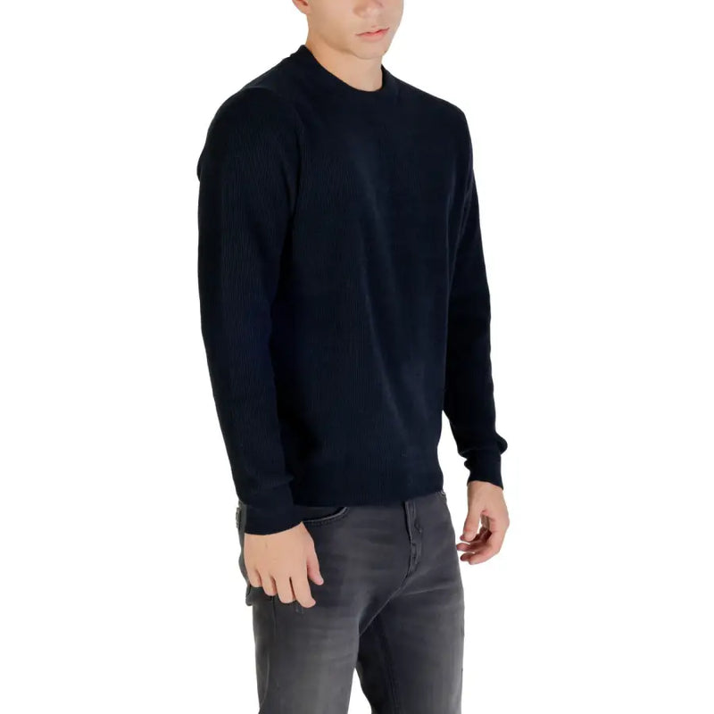 Black crew neck sweater with ribbed cuffs and hem, likely made of cotton or wool.