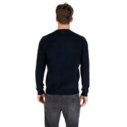 Navy blue crew neck sweater with ribbed cuffs and hem, likely made of cotton or a similar soft fabric.