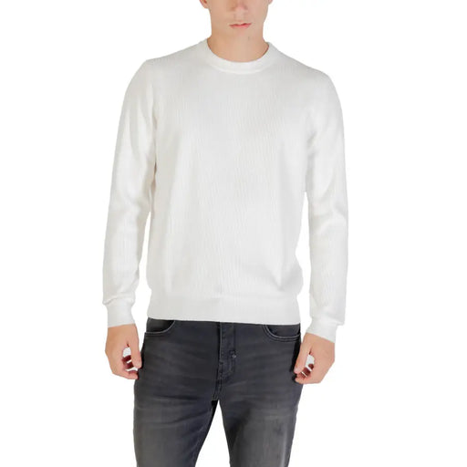 White crew neck sweater with long sleeves and ribbed cuffs, likely made of cotton or a similar soft fabric.