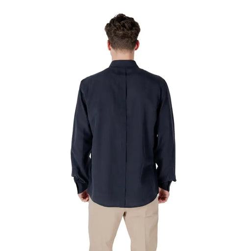 Men’s navy blue long-sleeve collared linen blend shirt with tan pants for sophisticated style