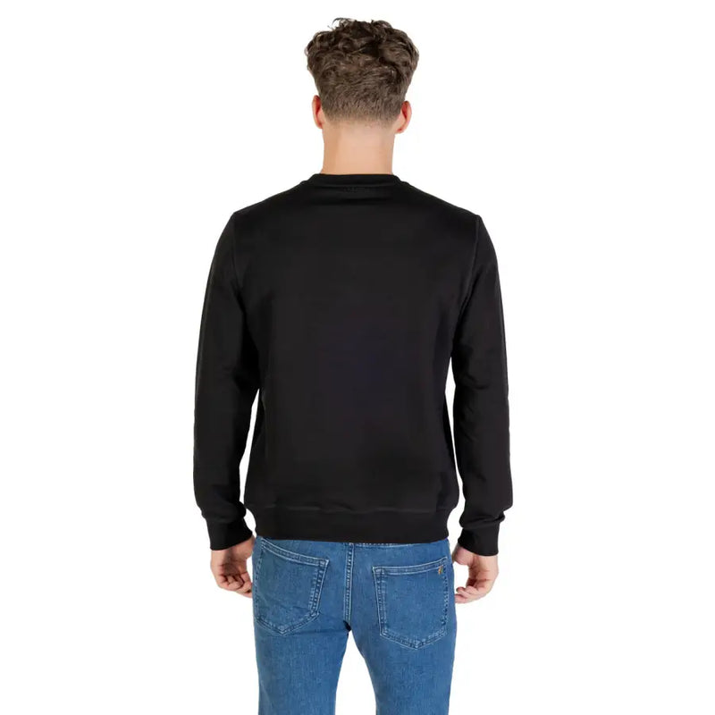 Men’s plain black crew-neck sweatshirt paired with blue jeans from Antony Morato Fall Winter collection