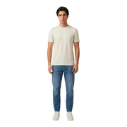 A man wearing an antony morato men t-shirt in cream with short sleeves and a crew neck paired with medium-wash blue jeans