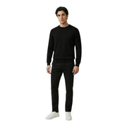 Antony Morato men knitwear black long sleeve cotton round neck sweater with subtle logo paired with black trousers and white sneakers