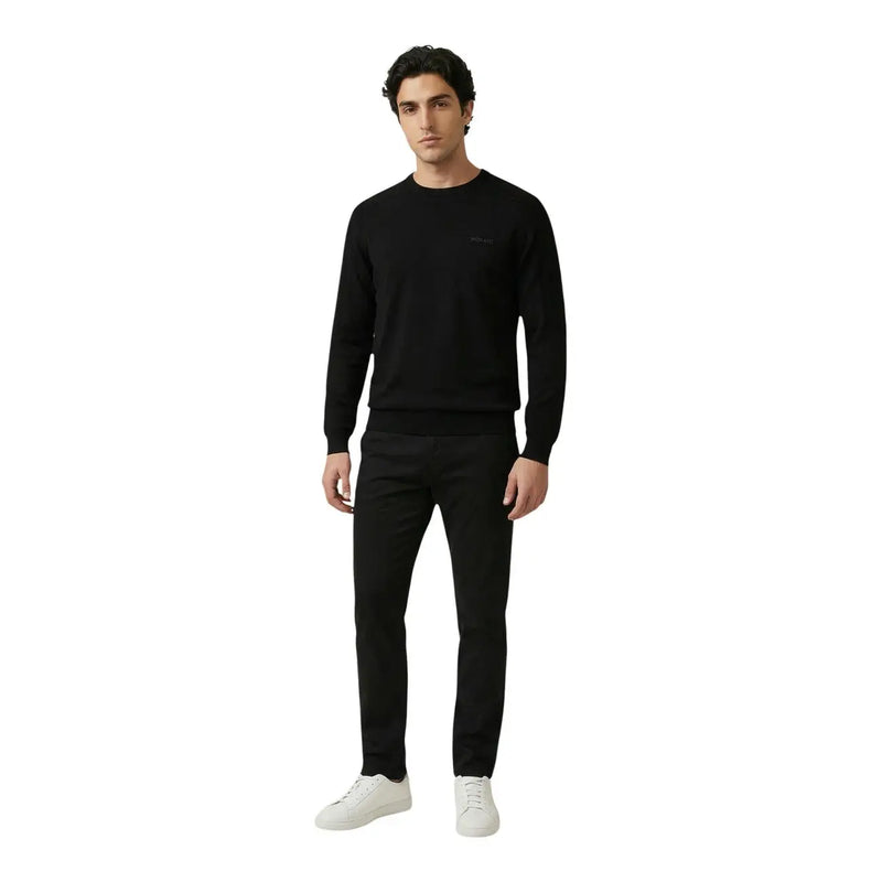 Antony Morato men knitwear black long sleeve cotton round neck sweater with subtle logo paired with black trousers and white sneakers