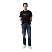 Black Calvin Klein cotton t-shirt with white logo paired with Antony Morato men Ozzy tapered fit blue cotton jeans