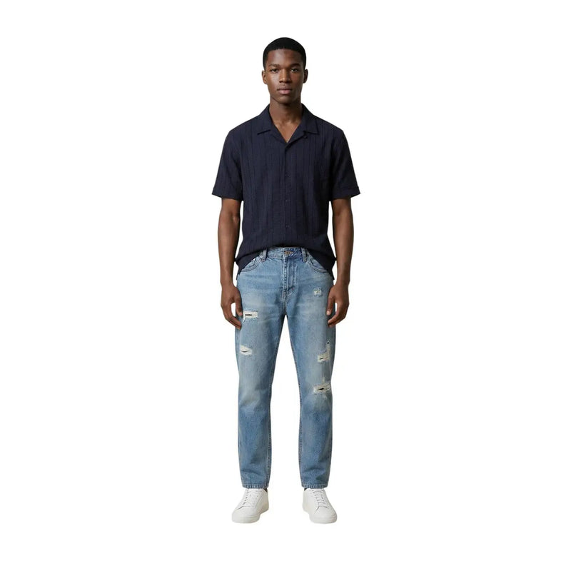 A pair of light-wash distressed denim jeans with ripped knees and thighs for men by Antony Morato