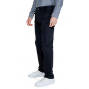Men’s black regular-fit cotton blend trousers with button closure, paired with gray shirt and white sneakers