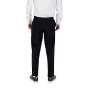 Men’s black trousers with white dress shirt and black sneakers from Armani Exchange
