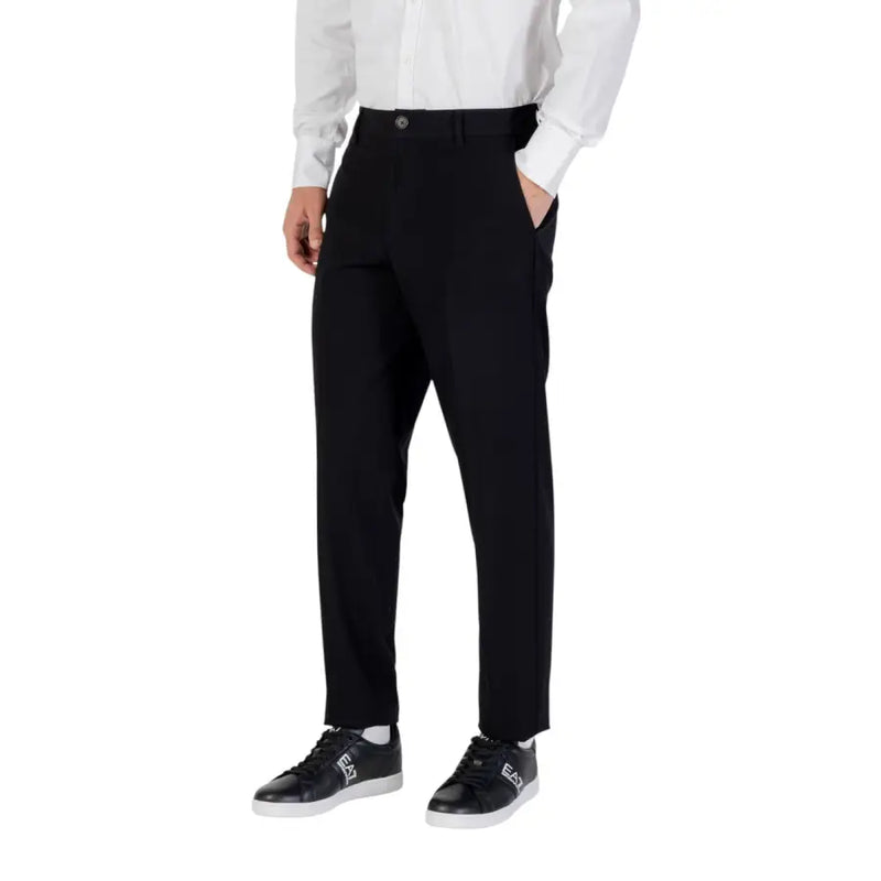 Men’s black trousers with white button-up shirt and black sneakers from Armani Exchange