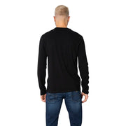 Men’s black long-sleeve crewneck cotton T shirt paired with blue jeans from Armani Exchange