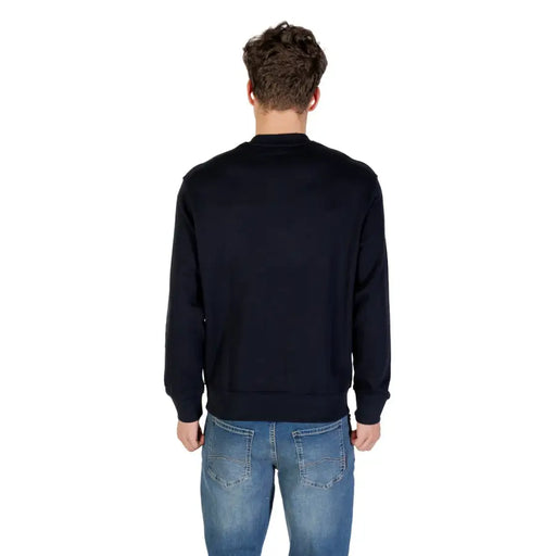 Men’s navy blue cotton crewneck sweatshirt paired with blue jeans from Armani Exchange