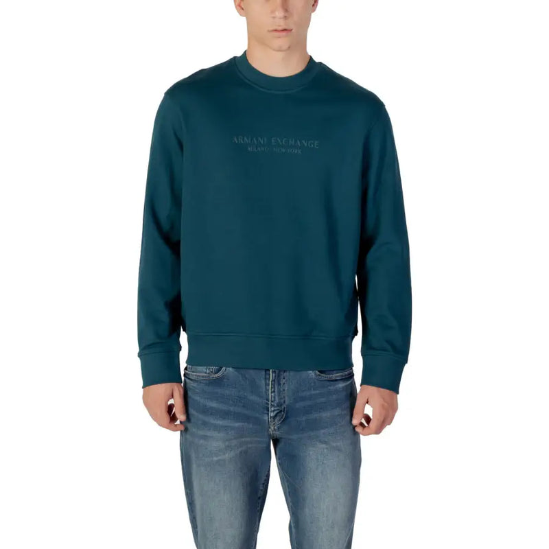 Men’s dark teal long-sleeve crewneck sweatshirt paired with blue jeans from Armani Exchange