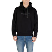 Men’s black hooded sweatshirt with drawstrings paired with light wash blue jeans