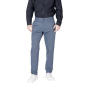 Men’s blue slim-fit cotton blend trousers paired with a black button-up shirt and white sneakers
