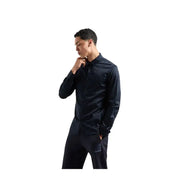Men’s long-sleeved black button-up shirt and black pants displayed with Armani Exchange branding