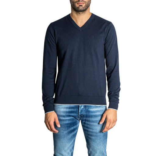 Navy blue v-neck sweater with ribbed cuffs and hem, likely made of cotton or wool blend.