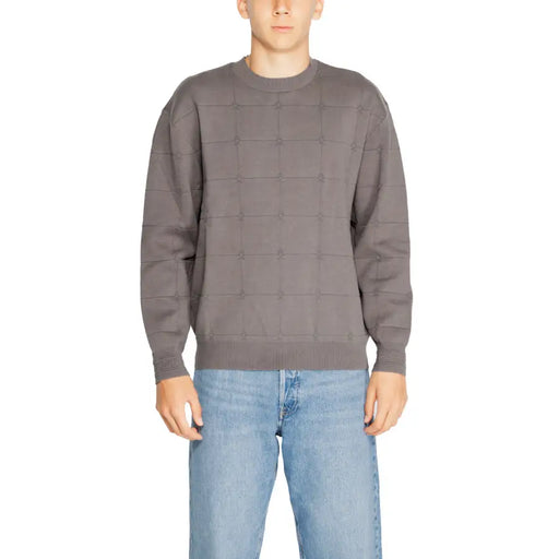 Charcoal gray sweater with geometric pattern and ribbed cuffs, collar, and hem.