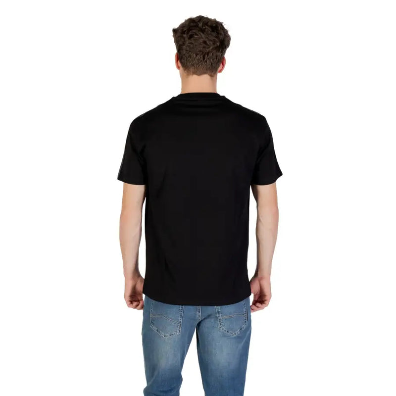 Men’s black short-sleeve round neck cotton T-shirt paired with blue jeans from Armani Exchange