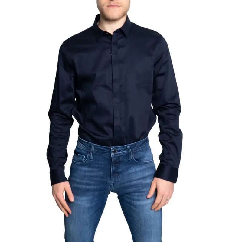 Man wearing Armani Exchange classic blue long sleeve button shirt and blue jeans