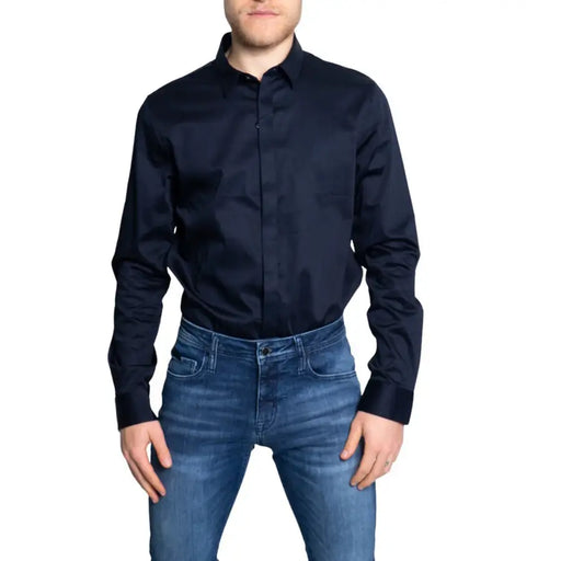 Man wearing Armani Exchange classic blue long sleeve button shirt and blue jeans