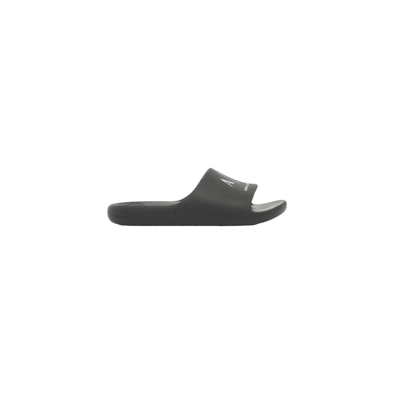 Black calvin klein slide sandal with minimalist design and subtle white logo on strap for men rubber slippers