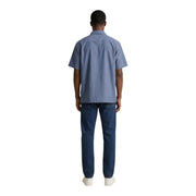 Ein Mann, der einen armani exchange hellblaues, kurzärmeliges Baumwollhemd und dunkelblaue Jeans