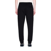Armani Exchange Herrenhose, schwarze Baumwoll-Jogginghose mit schmal zulaufendem Bein und gerippten Bündchen, Vorderansicht
