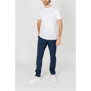 White cotton t-shirt with small logo on left chest paired with armani exchange mens blue trousers spring summer collection