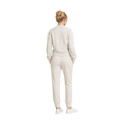 A woman wearing a beige Armani Exchange women sweatshirt and jogger pants with ribbed cuffs in viscose blend