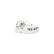 Armani Exchange women black slip on sneakers with white polyester upper featuring bold black zebra stripes and metallic accents