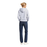 A woman wearing an Armani Exchange women grey cotton hooded sweatshirt paired with dark blue denim jeans