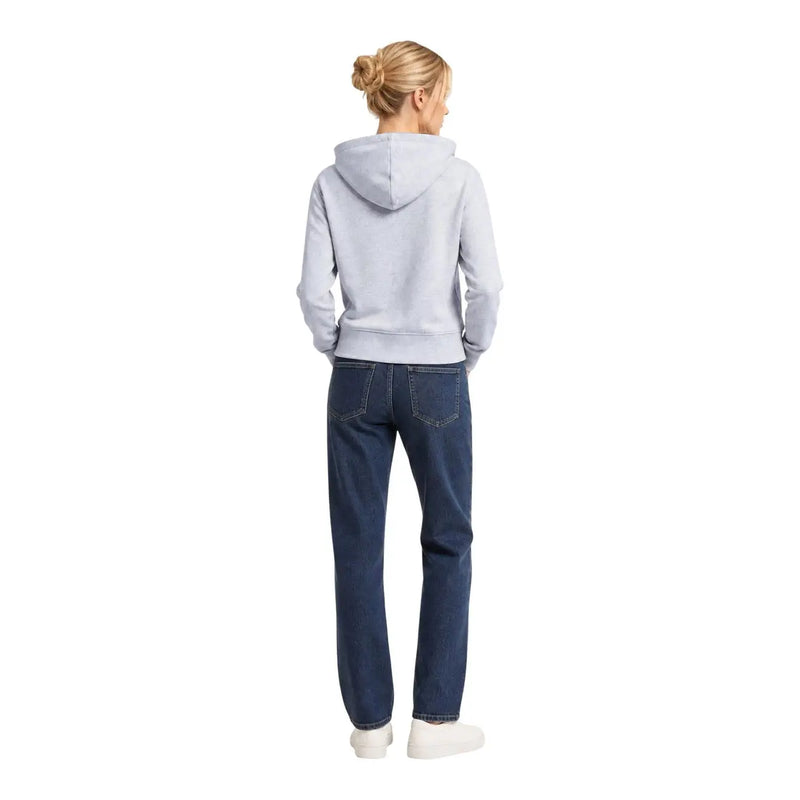 A woman wearing an Armani Exchange women grey cotton hooded sweatshirt paired with dark blue denim jeans