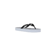 Armani Exchange women white rubber flip flops with black and white textured patterned sole shown from the back side