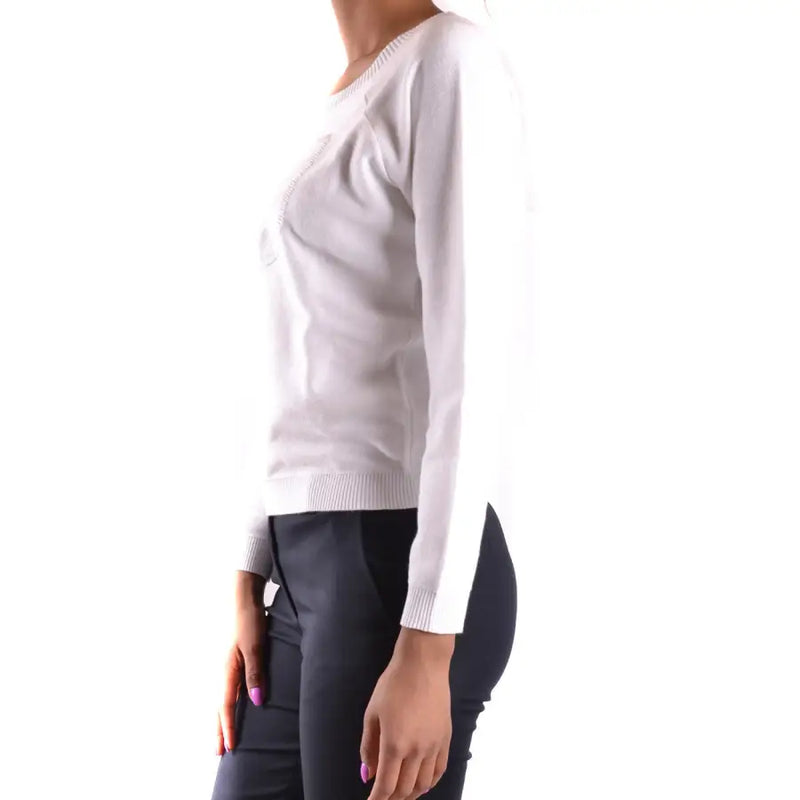 Woman wearing Armani Jeans white cotton round neck knit top with long sleeves and black trousers