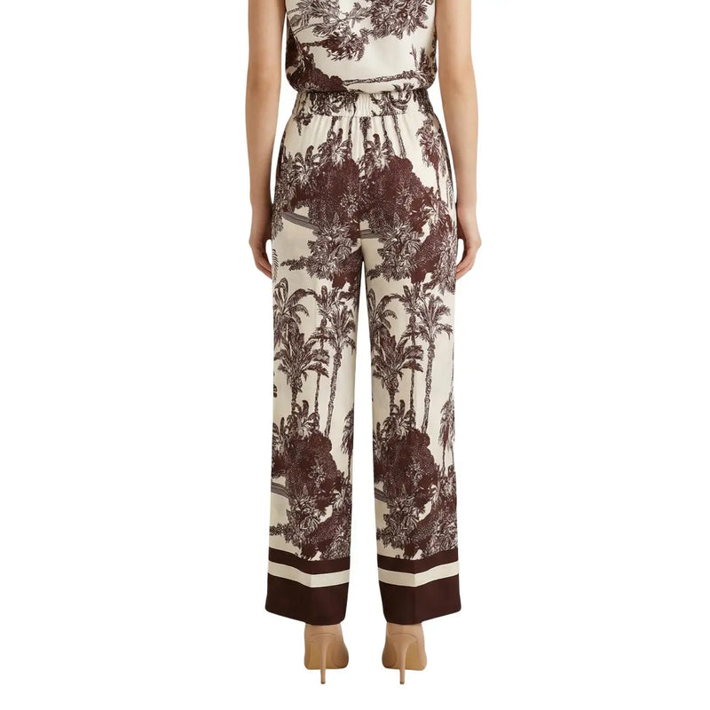 Cremefarbene Seidenhose mit weitem Bein, auffälligem braunem Tropenmuster und gestreiften Bündchen aus der Frühjahr/Sommer-Kollektion von Artigli.