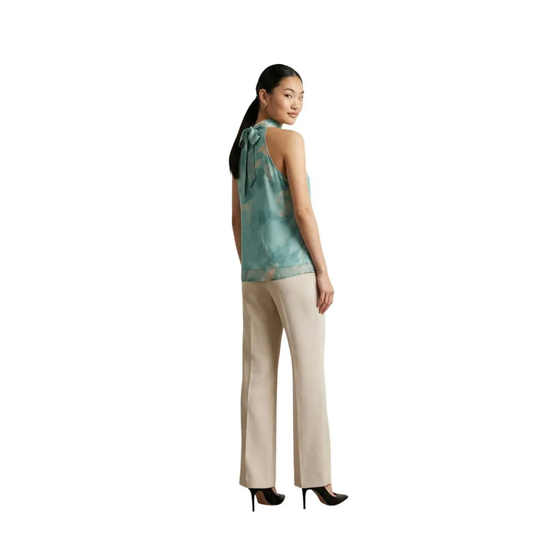 Artigli Damen ärmelloser Rollkragenpullover top aus grünem Polyester mit türkisfarbenem und weißem abstraktem Muster und Schleife am hinteren Halsausschnitt