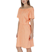 A soft peach b.young orange polka dot short off-the-shoulder dress with delicate white dot pattern and short sleeves