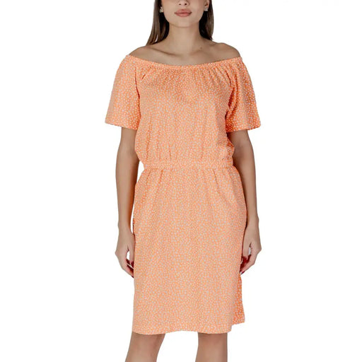 A soft peach off-the-shoulder B.young orange polka dot short dress with subtle white dots and short sleeves