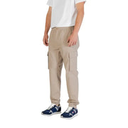 Beige cargo pants with multiple pockets displayed on a clothing rack