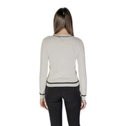 Beige long sleeve knit cardigan with off-white fabric black trim and front pockets in a sleek design