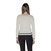 Beige long sleeve knit cardigan with off-white fabric black trim and front pockets in a sleek design
