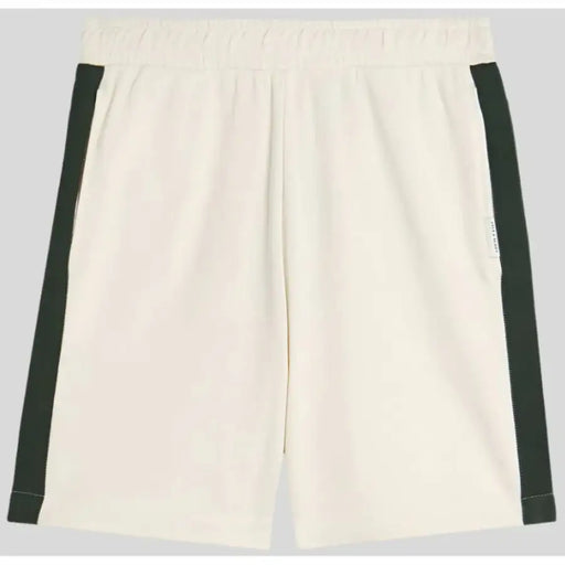 Beige shorts with dark green side stripes displayed on a model