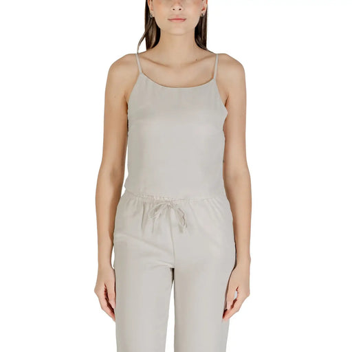 Beige sleeveless round neck polyester top for women with delicate spaghetti straps and gathered waistband in light gray